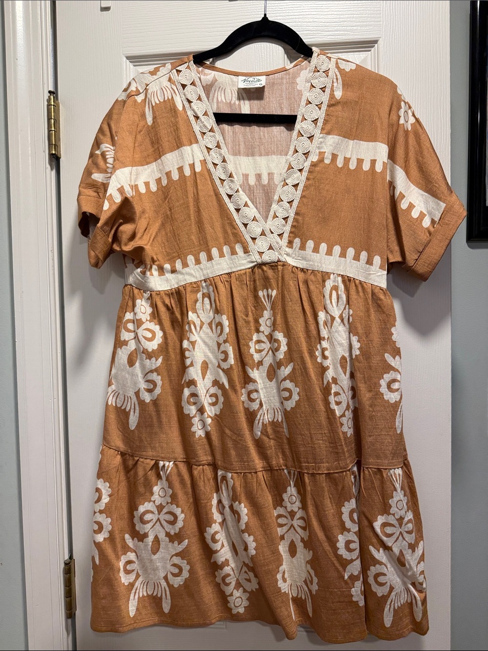 Light brown and cream dress with embroidered design on a deep v neck